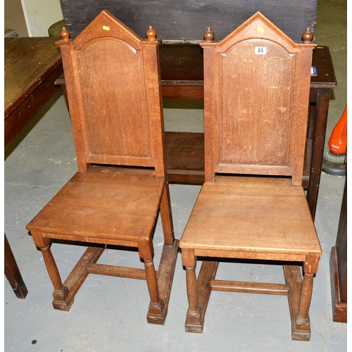 23 - A pair of antique Gothic style oak hall chairs