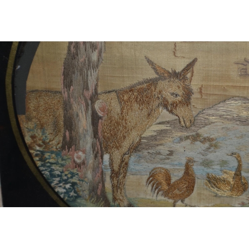 279 - A Georgian/ 19th century needlework of a man with Donkey and birds set within a Verre Eglomise frame