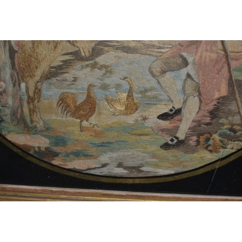 279 - A Georgian/ 19th century needlework of a man with Donkey and birds set within a Verre Eglomise frame