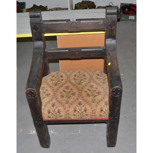 28 - A heavily carved Gothic style oak armchair - possibly Welsh