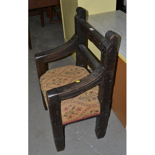 28 - A heavily carved Gothic style oak armchair - possibly Welsh