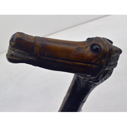 354 - An unusual vintage folk art carved riding whip or crop. The handle carved as a horses head with some... 