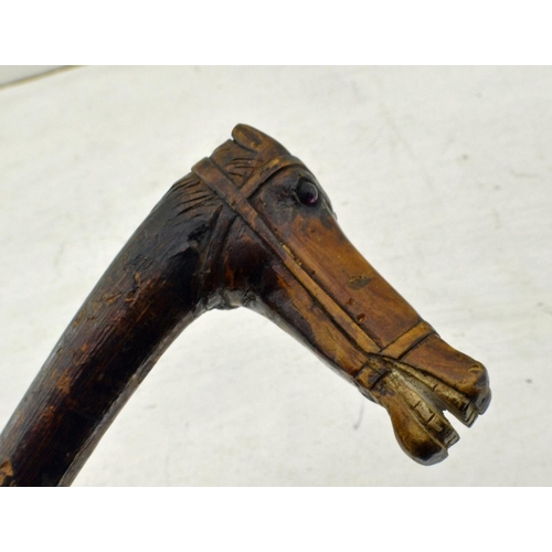 354 - An unusual vintage folk art carved riding whip or crop. The handle carved as a horses head with some... 