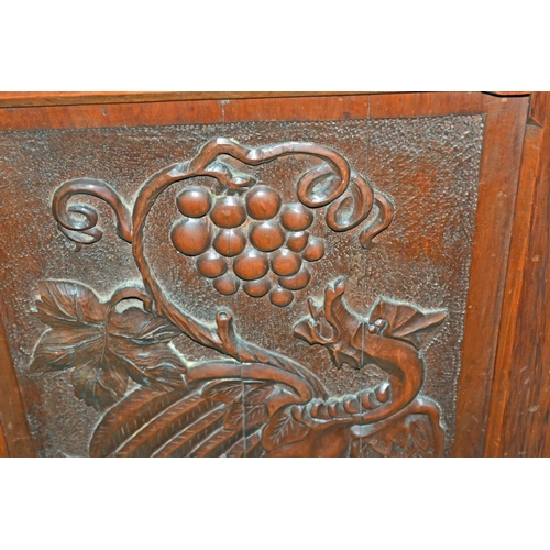 72 - An antique carved wooden corner cupboard with dragon motif