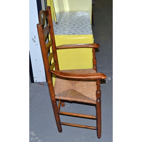 81 - An antique ladder back country farmhouse chair with rush seat