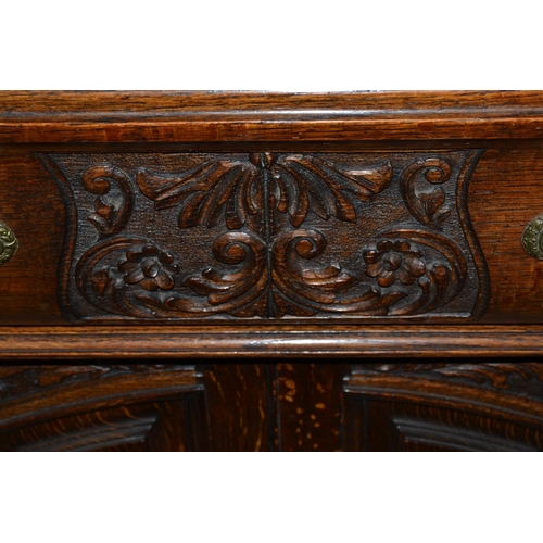 86 - A large early 20th century carved oak sideboard