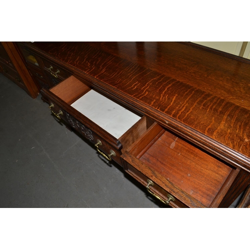 86 - A large early 20th century carved oak sideboard