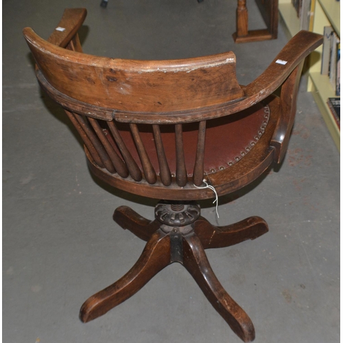 96 - An early 20th century wooden office swivel chair with metal fittings