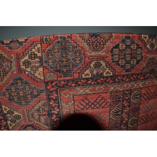 128 - A large red ground rug