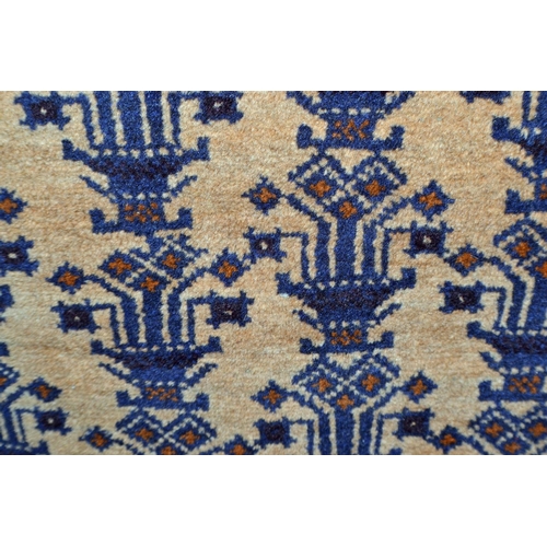 131 - A vintage blue and cream ground rug