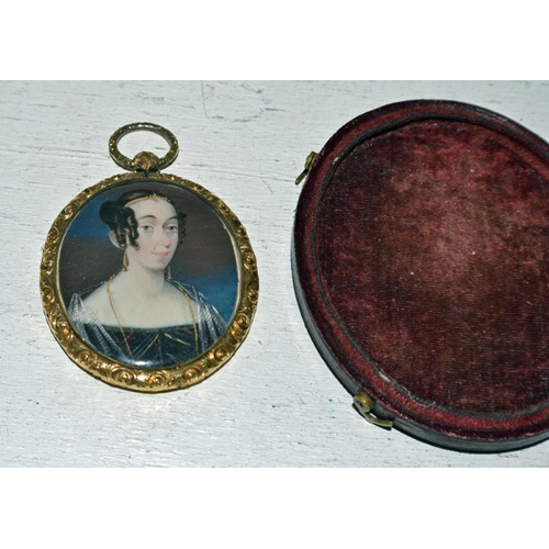 283 - A miniature watercolour miniature on ivory of a young lady set within a yellow metal frame - comes c... 