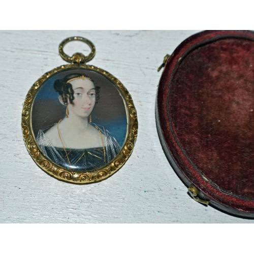 283 - A miniature watercolour miniature on ivory of a young lady set within a yellow metal frame - comes c... 