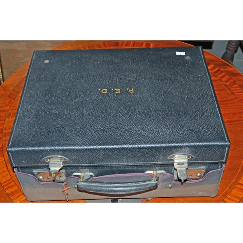 650a - A Moroccan leather travelling vanity case with silver mounted bottles etc to the interior. The whole... 