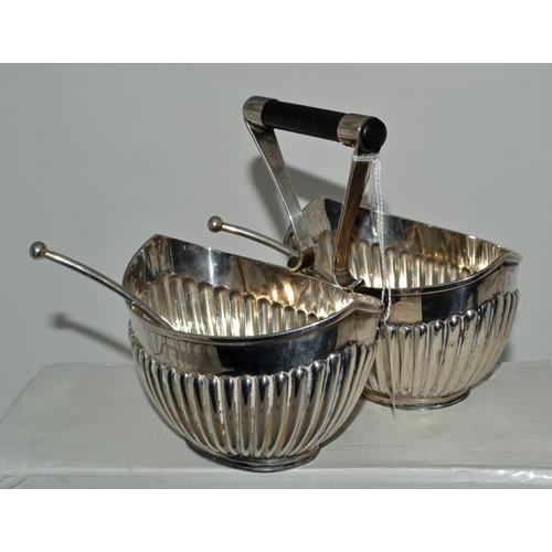 652 - A Silver double sugar bowl with ebonised wooden handle in the style of Christopher Dresser with 2 or... 