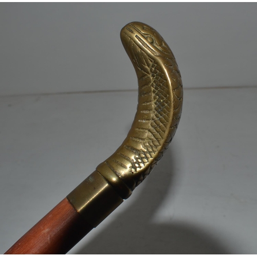 720 - An unusual brass headed walking stick formed as a Cobra with a drinking vial compartment