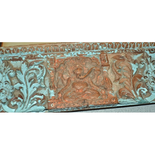 215 - An Indian carved wooden panel depicting Ganesh amongst foliage - likely 19th century with painted de... 