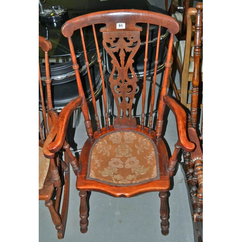 91 - An antique stick back bedroom arm chair with fabric seat