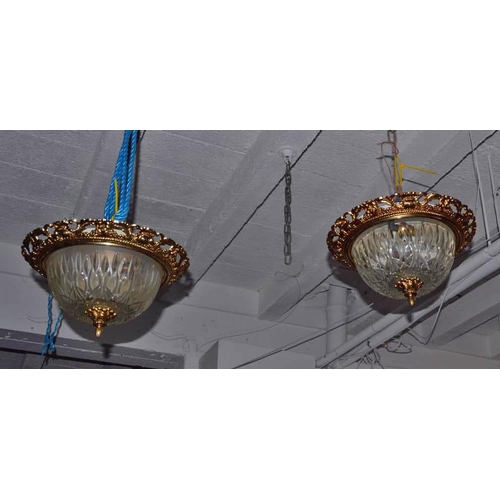 100a - A pair of gilt metal and cut glass hanging lampshades