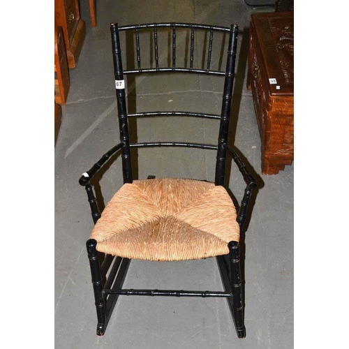 67 - Victorian ebonised child's rocking chair with rush seat