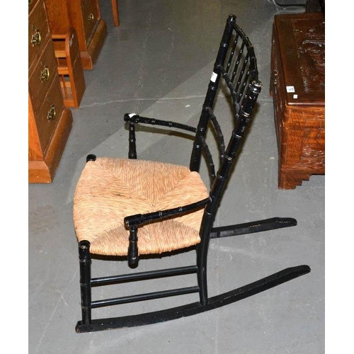 67 - Victorian ebonised child's rocking chair with rush seat