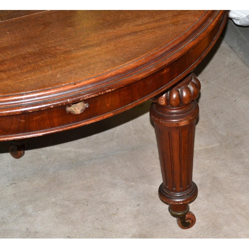 115 - A Victorian mahogany dining table on impressive carved legs