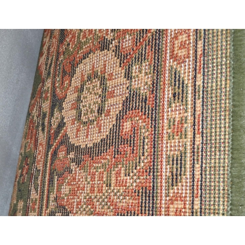 120 - A large green ground rug