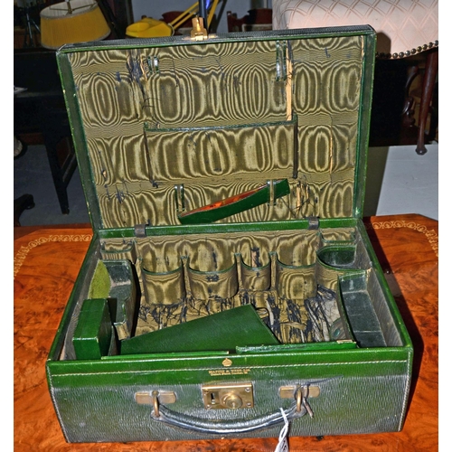 164 - An antique green Moroccan leather Mappin & Webb travelling case with some contents