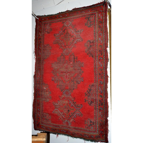 233 - An old red ground rug