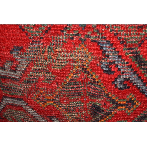 233 - An old red ground rug