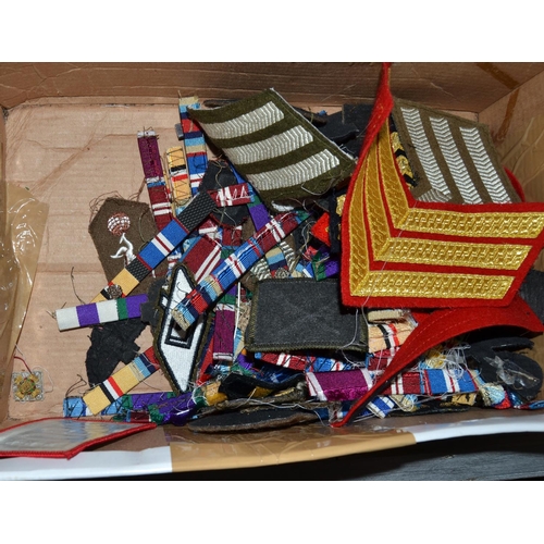 605 - A qty of medal bars and ribbons, military badges and patches etc