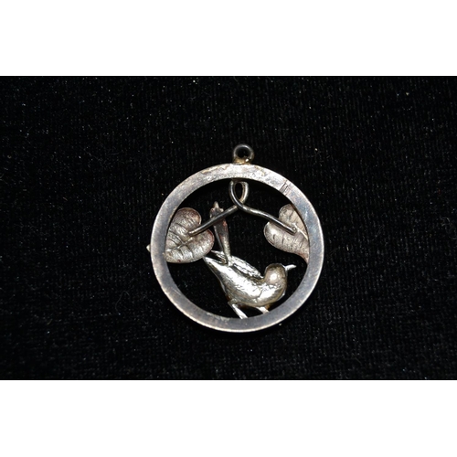 666 - A silver and enamel pendant in the shape of a bird