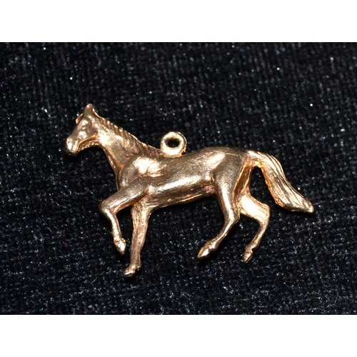 690 - A 9ct gold charm of a Horse