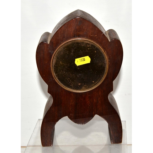 724 - An antique clock in unusual lancet shaped wooden case