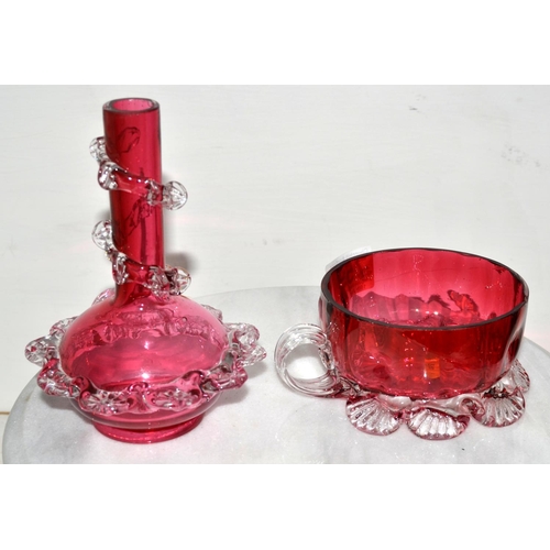 759 - An antique cranberry glass wine taster and a vase