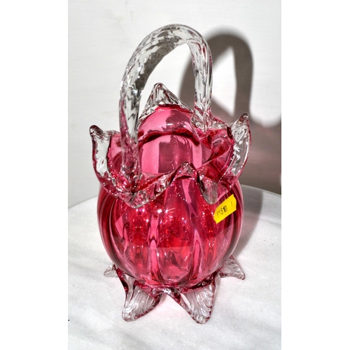 761 - An antique cranberry glass basket vase