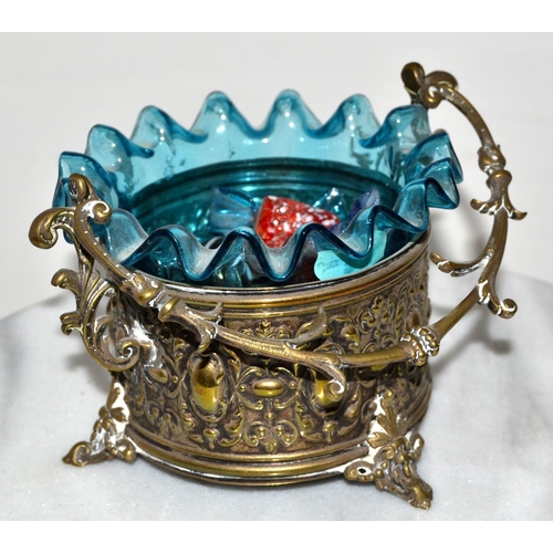 765 - An antique silver plated dish with frilled glass liner containing glass sweets