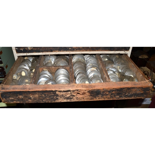 825 - A vintage 8 drawer chest containing 100's of new old stock watch glasses