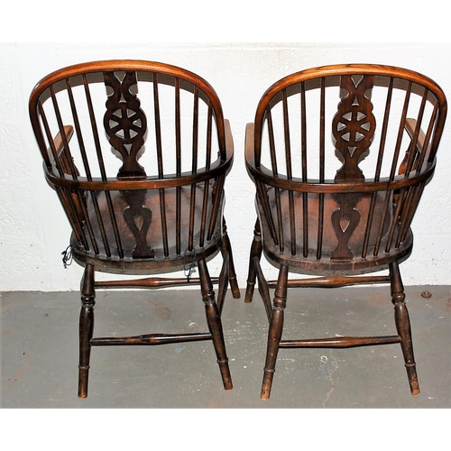 131a - A pair of antique Elm seated wheel back country armchairs