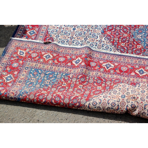 26 - A large red and blue ground rug with Herati border