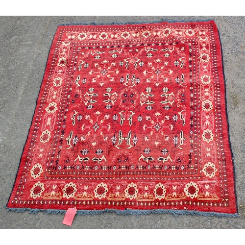 28 - A vintage red rug decorated with animals