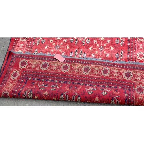 28 - A vintage red rug decorated with animals