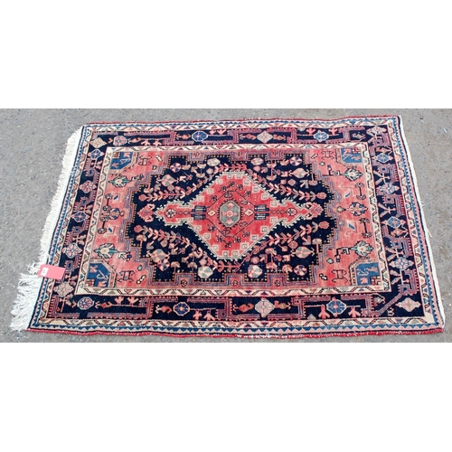 31 - A red and blue ground medallion rug