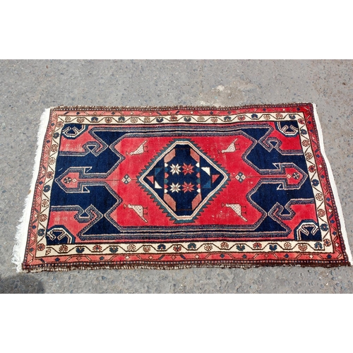 33 - A small red and blue ground rug