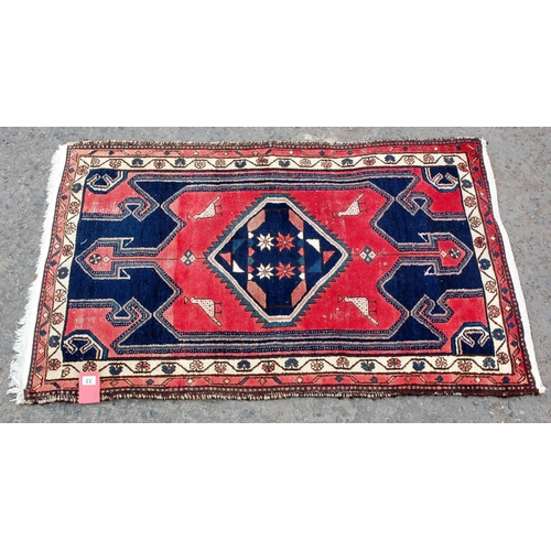 33 - A small red and blue ground rug