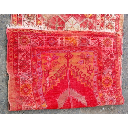 35 - A vintage red ground Prayer rug of larger size