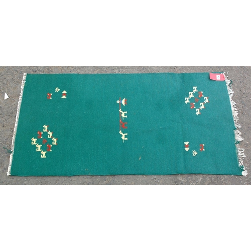 43 - An unusual green Kilim style flatweave rug decorated with people and animals