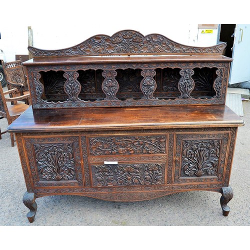 222a - An antique carved wooden Anglo-Indian sideboard decorated with vines and Lotus flowers and a snakesk... 