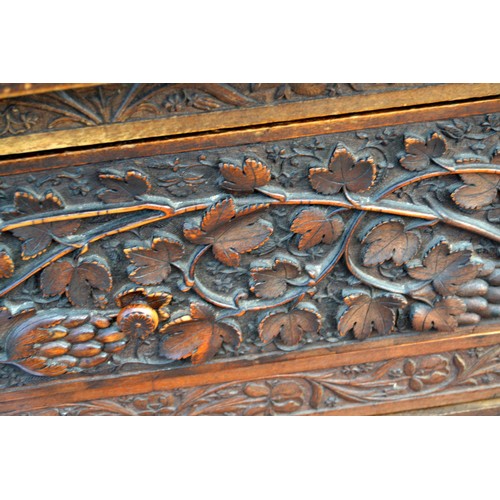 222a - An antique carved wooden Anglo-Indian sideboard decorated with vines and Lotus flowers and a snakesk... 