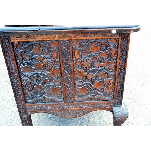 222a - An antique carved wooden Anglo-Indian sideboard decorated with vines and Lotus flowers and a snakesk... 