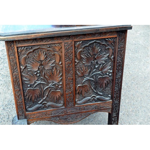 222a - An antique carved wooden Anglo-Indian sideboard decorated with vines and Lotus flowers and a snakesk... 